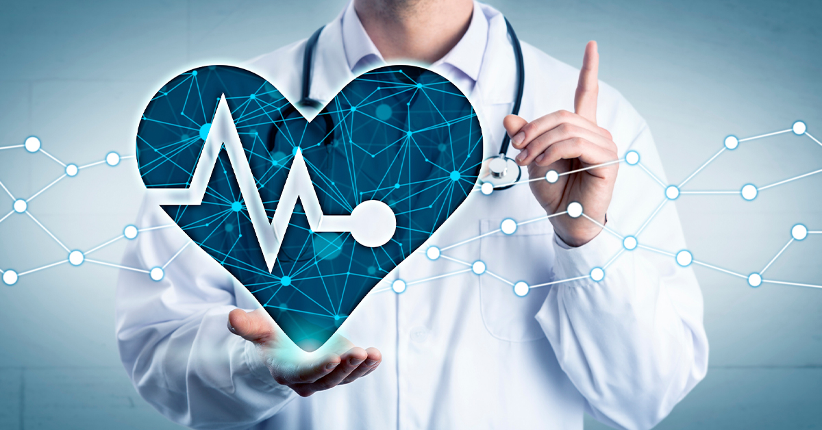 Doctor wearing a white lab coat and a stethoscope around their neck holding a blue heart graphic holding one finger in the air.